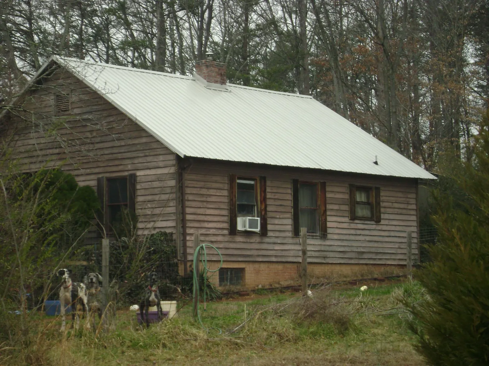 White metal roof on an old wood sided farmhouse, from a Metal Roof Installation job in Pinckneyville